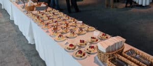 A lunch buffet is set with warming dishes and desserts. Great food is just the start of hiring a caterer
